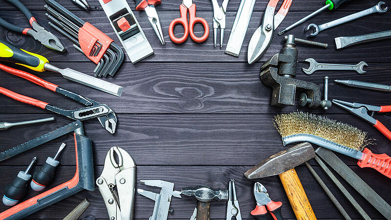 Background with various tools on wooden workbench